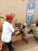 Our Project Leader giving food items to the poor