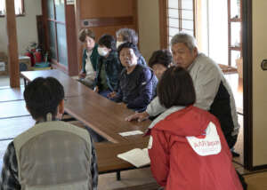 AAR staff (foreground) listening at a meeting