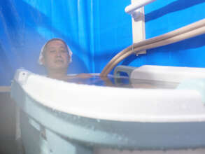 A survivor comfortably soaks in a bathtub