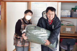 People at a facility receiving winter clothes