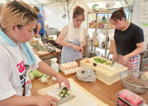 Regina (center) cooking Afritada with her friends