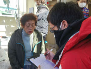 AAR staff interviewing an elderly woman