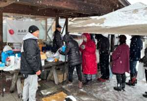 Evacuees line up for a soup kitchen