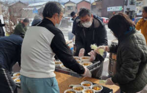 Survivors receiving AAR's soup meal in Wajima city