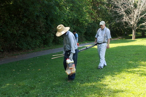 Mitch carries supplies to the garden plot