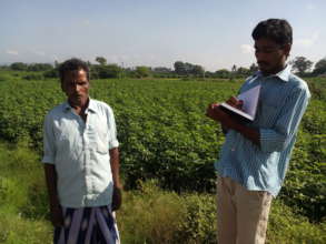 Youth volunteer taking notes from farmer-Oct 2015