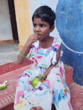 A happy child taking organic, self grown fruit