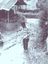 A community representative taking water samples