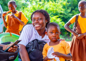 World Inspiring Network staff with beneficiary