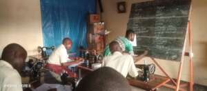 A supervisor gives notes on kitchen items