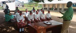 A doctor addressing students at health facility