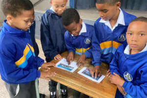 School boys discussing a DICT Penguin assignment