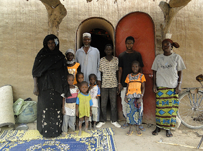 Family in Dendjola in front of their NV house