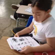 Concentrating on her workbook