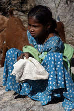 Timi eats her lunch in solitude, with the goats