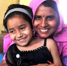 Meena with a young girl from the community