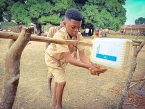 A schooboy washing his hands