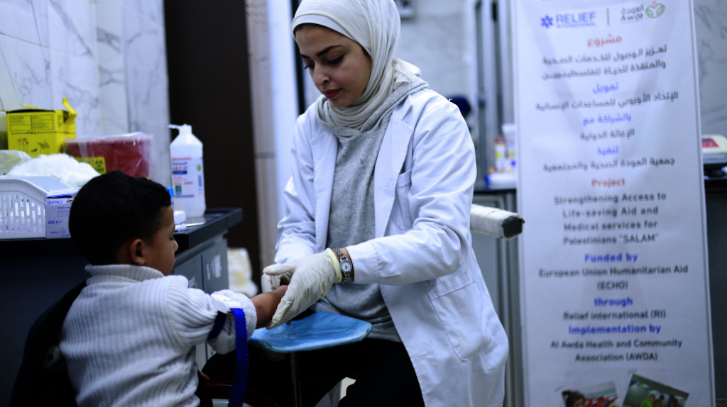 A member of staff and patient at Al-Awda hospital