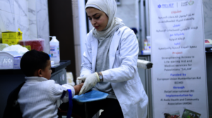 A member of staff and patient at Al-Awda hospital