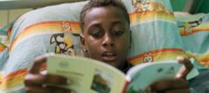 Evans, 7, reading The River of Nabeau
