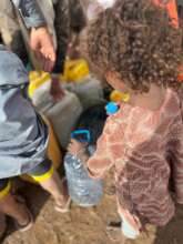 LITTLE GIRL WITH HER BOTTLE