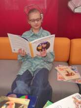A young girl reading a book in Ukrainian