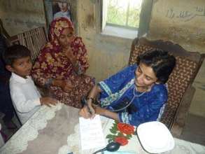 Doctor treating patient during free medical camp