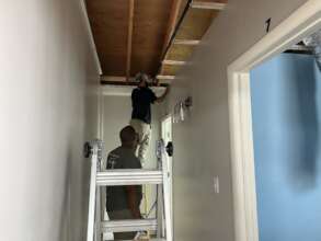 Volunteers install a new ceiling