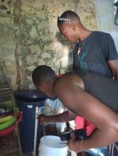 Venel and Junnot doing Biosand filter follow ups
