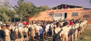 School children line up ready for school
