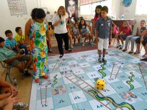 Kids playing anti sexual abuse snake and ladder