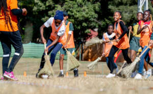 Learners playing Broom Hockey at our Olympic Day