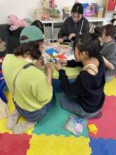 Volunteers from Japan lead an origami session