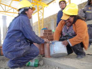 Women builders practicing on a construction site.