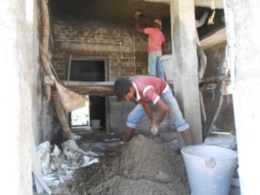 Cement concrete is being mixed for Masonry work
