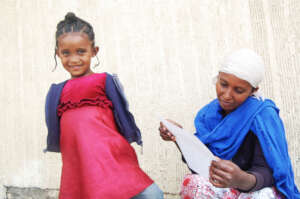 Selam and her mother smiling candidly