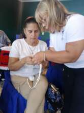 Lead weaver teaching a visually impaired person ho
