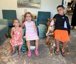 3 Kids in their Children's Chairs