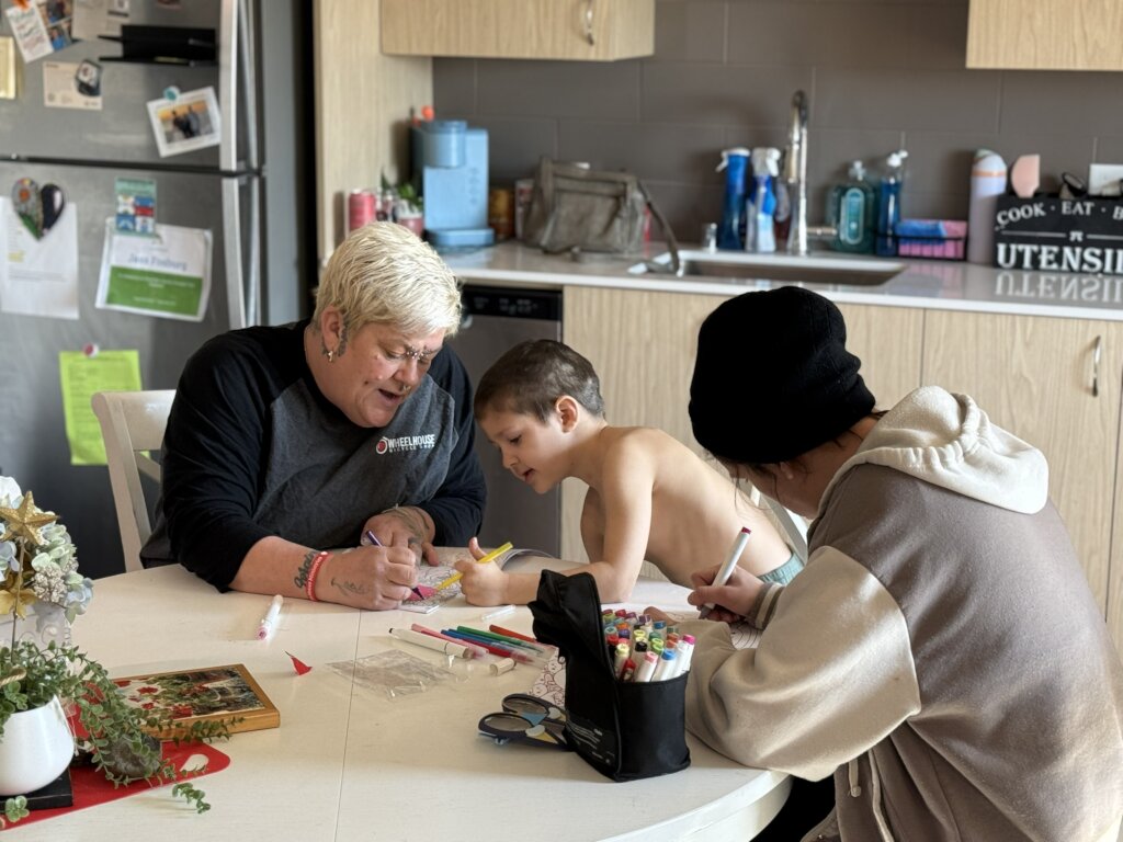 Former client Ange coloring with her family