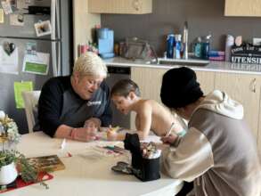 Former client Ange coloring with her family