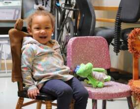 A little girl in her own chair