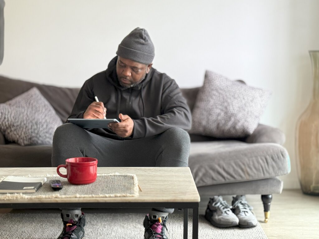 Saleam sketching in his new living room.