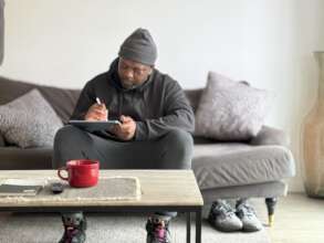 Saleam sketching in his new living room.