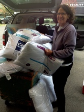 Founder Roz with a huge donation of new pillows