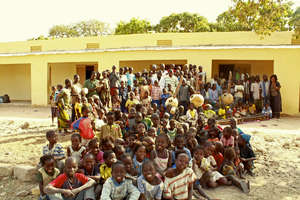Students and teachers in front of the school