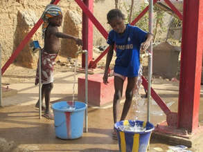 Village children try out the new well's pumps.