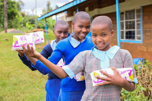 Students holding samples of the sanitary towels