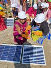 Women doing solar panel set-up and maintenance