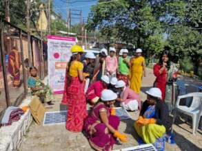 Women attending a solar panel set-up demonstration