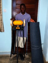 Isaaya posing with his Shoemaking Start up capital